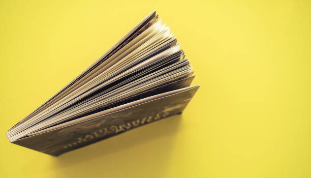 Beautiful book top view on a yellow background table.