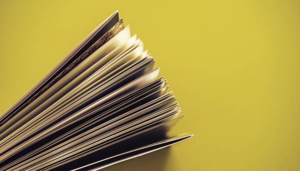 Close up beautiful book top view on a yellow background table.