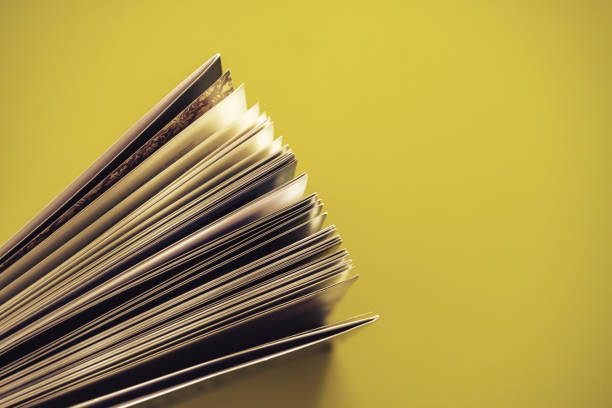 istock Close up beautiful book top view on a yellow background table. 1176079191
