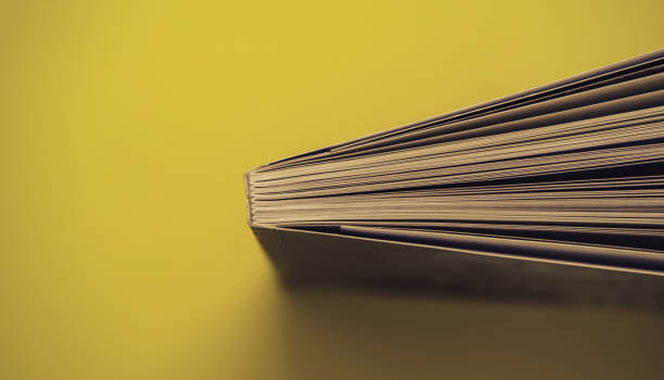 istock Close up beautiful book top view on a yellow background table. 1176079210