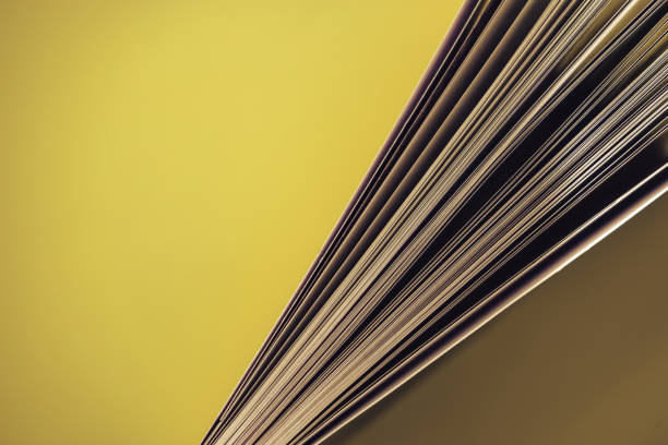 istock Close up beautiful book top view on a yellow background table. 1176079231