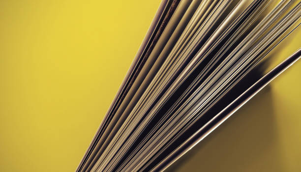 istock Close up beautiful book top view on a yellow background table. 1176079248