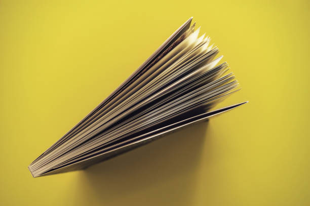 istock Beautiful book top view on a yellow background table. 1176079261