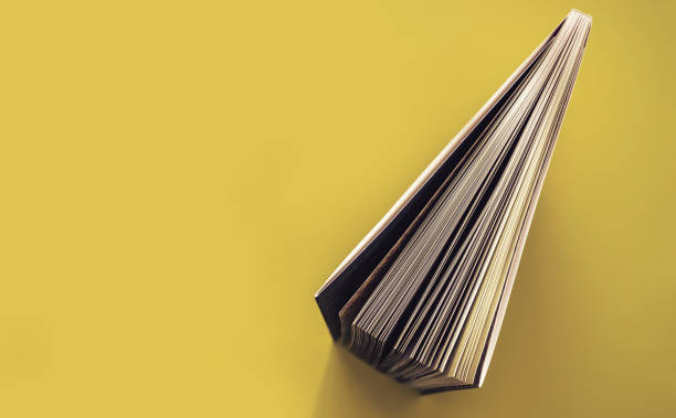 istock Beautiful book top view on a yellow background table. 1176079268