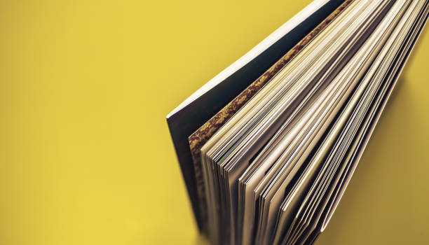 istock Close up beautiful book top view on a yellow background table. 1176079291