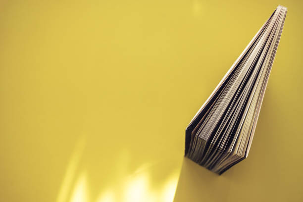 istock Beautiful book top view on a yellow background table. 1176079312