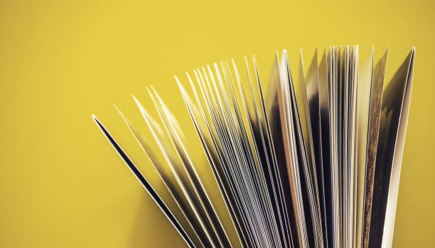istock Close up beautiful book top view on a yellow background table. 1176079367