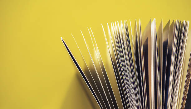 istock Close up beautiful book top view on a yellow background table. 1176079420