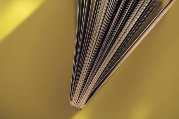 istock Close up beautiful book top view on a yellow background table. 1176079609