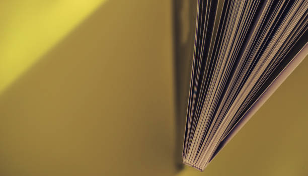 Close up beautiful book top view on a yellow background table.