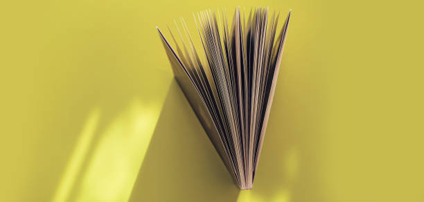 Beautiful book top view on a yellow background table.