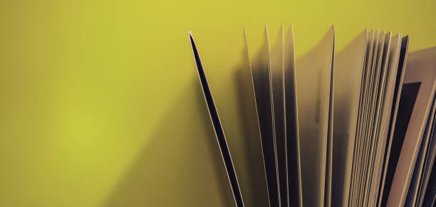 istock Close up beautiful book top view on a yellow background table. 1176080175