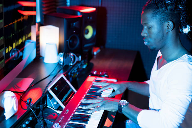 istock Young serious African-american man making new music while sitting in studio 1176082535