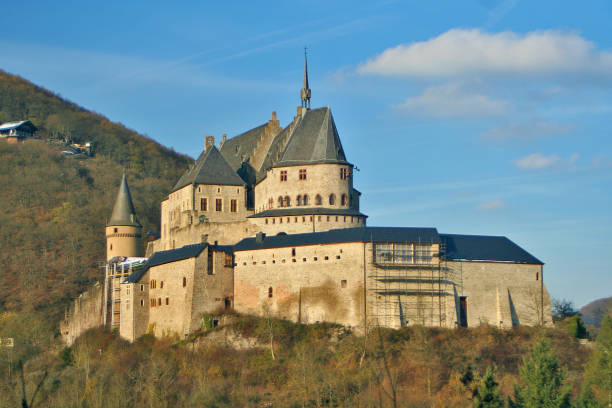 Gothic Vianden castle. Diekirch, Luxembourg Luxembourg - Vianden - The wall, spire and tower of gothic Vianden castle (aka Chateau de Vianden or Burg Vianden) at sunny fall day vianden stock pictures, royalty-free photos & images
