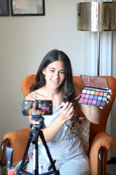 istock Young female vlogger recording a make-up video for her vlog 1176084077