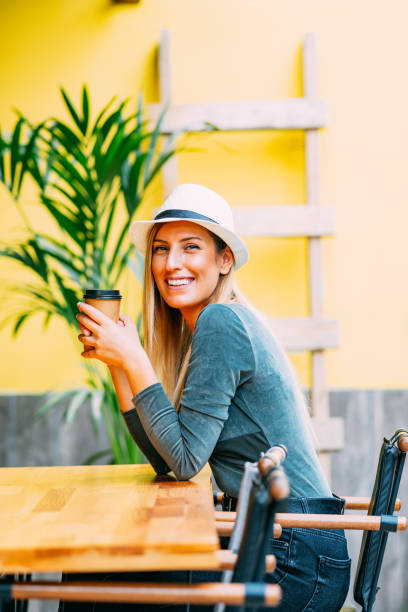 istock Beautiful Blond Woman Drinking Coffee in Cardboard Cup 1176084084