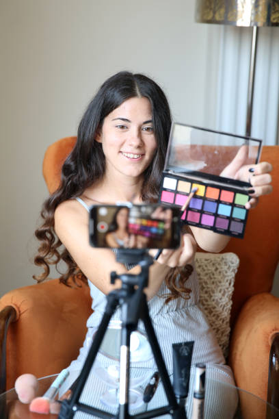 istock Young female vlogger recording a make-up video for her vlog 1176084170