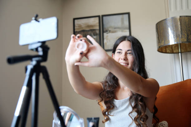 istock Young female vlogger recording a make-up video for her vlog 1176084224