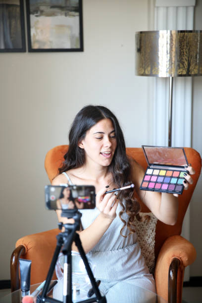 istock Young female vlogger recording a make-up video for her vlog 1176084274