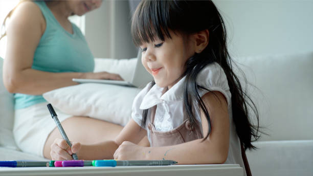istock An Asian mother Teaching Her Daughter to Draw 1176086282