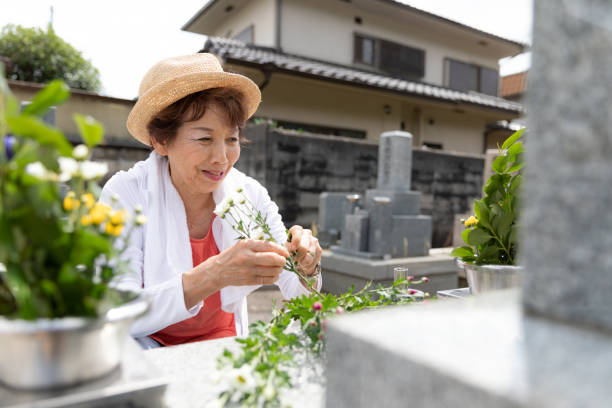 istock Senior woman visiting family grave 1176088366
