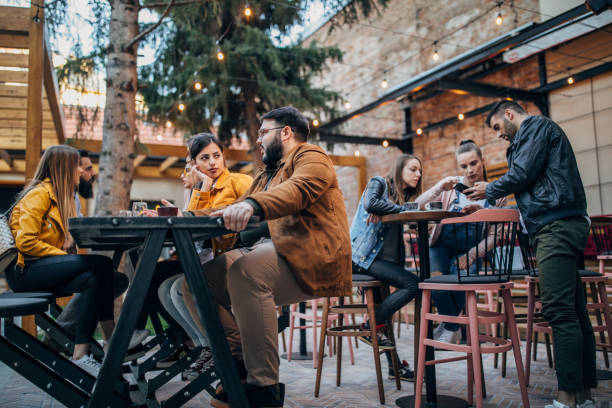 istock Group of young joyful friends having fun in a pub 1176088675