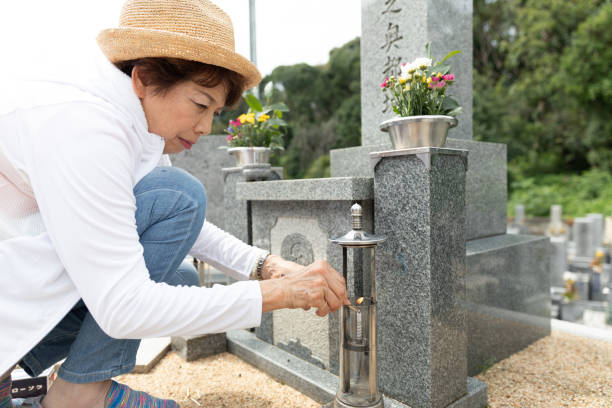 istock Senior woman visiting family grave 1176089009