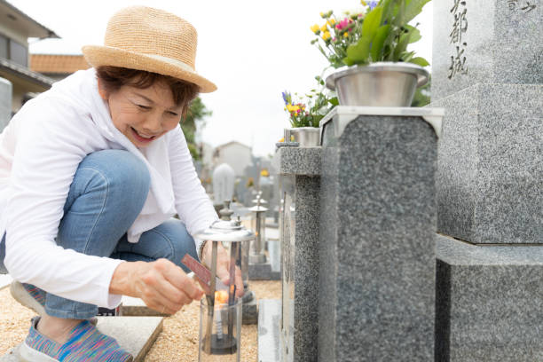istock Senior woman visiting family grave 1176089430