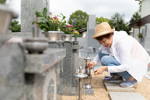 Senior woman visiting family grave