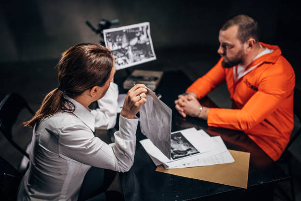 istock Prisoner and female detective 1176091106
