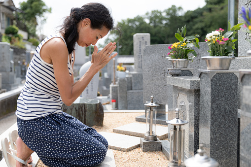 Senior woman visiting family grave