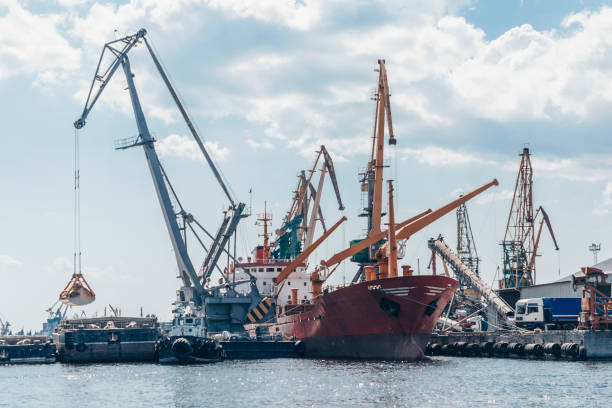 istock Port cranes and equipment for loading and unloading cargo. The concept of transportation of goods by water. 1176092030