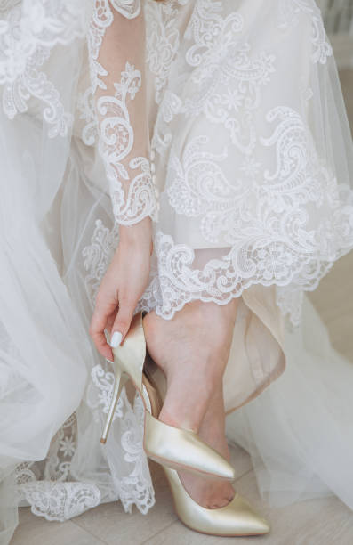 istock sitting bride dresses white heel shoes conceptual 1176092150