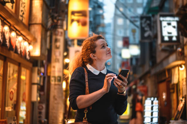 istock Female Vacationer Using Smart Phone for Sightseeing in Tokyo 1176093254