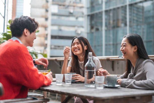 istock Three Chinese friends talking and having fun at a cafe 1176096498
