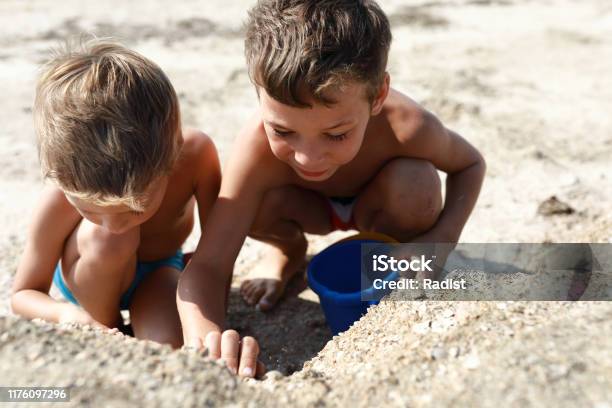 AZOV films boys Boys On Beach Of Sea Of Azov Stock Photo - Download Image Now - Activity, Beach, Brother - iStock