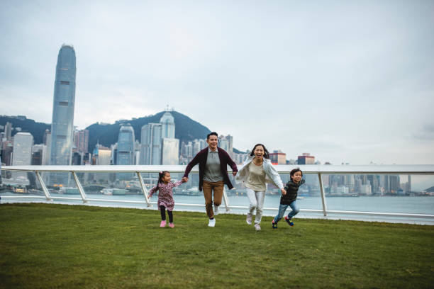 istock Young Chinese Family Running Across Ocean Terminal Deck 1176097918