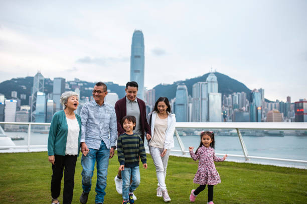 chinese family walking across ocean terminal deck - harbour city imagens e fotografias de stock