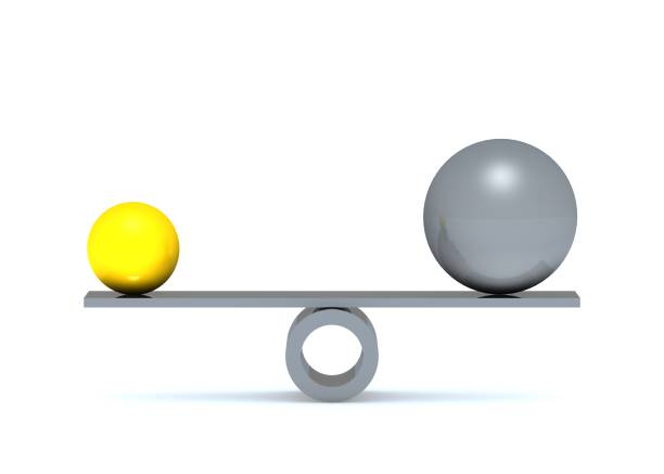 istock Gold Silver balls on a scale balance 1176101225