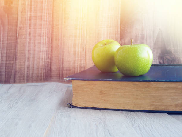 composition of books, stationery and an apple on the teacher, apple, books and colored pencil, back to school concept - apple for the teacher imagens e fotografias de stock