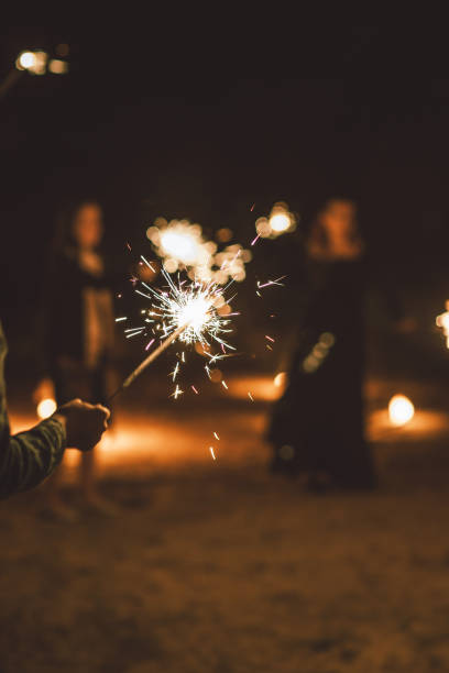 istock Burning sparkler candle in hand, celebration event party, vertical background 1176103601