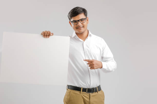istock Indian/Asian Young Man showing blank signboard on White background 1176106553