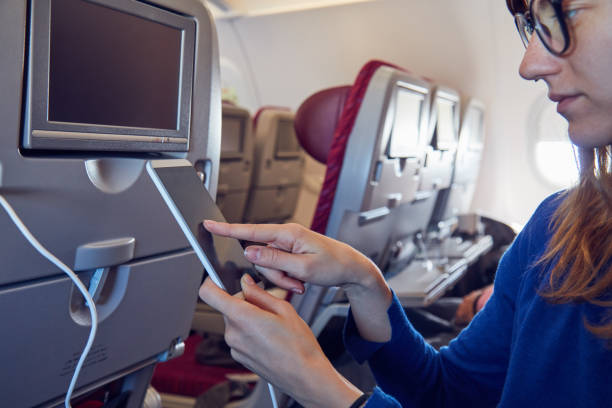 istock Woman using cellphone in modern airplane seat. 1176107520