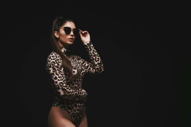 istock Alluring young brunette in leopard bodysuit 1176110739