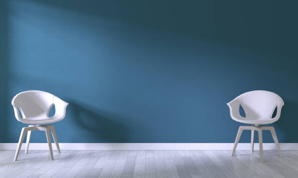istock white chair on room dark blue wall background.3D rendering 1176114878