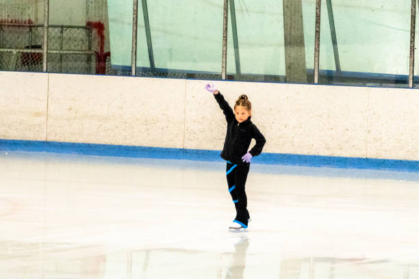 istock Little figure skater in black clothes practicing 1176115033