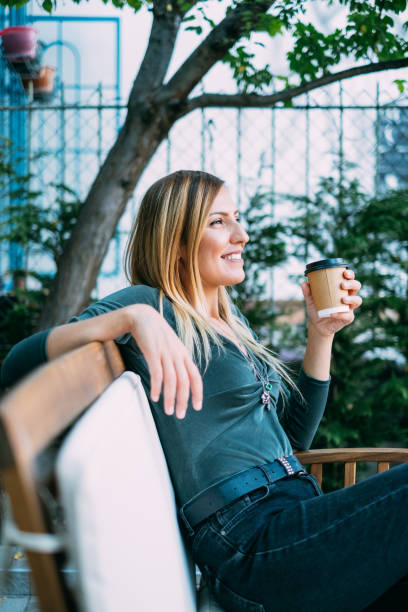 istock Blond Woman Drinking Coffee in Cardboard Cup 1176116623