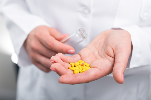 Photo Of Doctor Prescribes Pills And Antibiotics Stock Photo Download photo-of-doctor-prescribes-pills-and-antibiotics-stock-photo-download