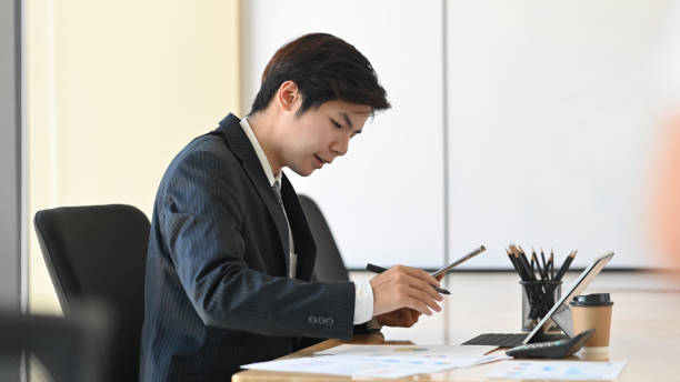 istock Asian manager working on modern office with finance data. 1176125368
