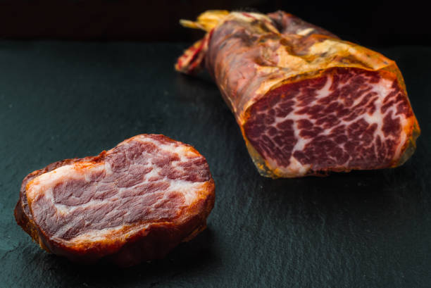 istock delicious Iberian pork loin on black background 1176126780
